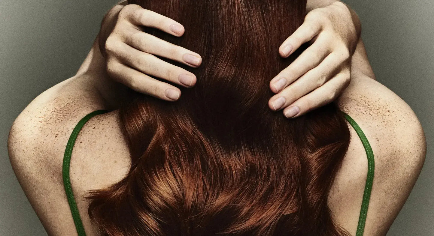 Red haired girl with fingers in her hair